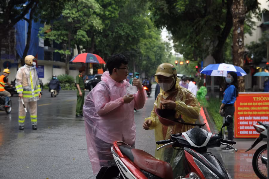 Buổi sáng ngày 12/6, khu vực Hà Nội có mưa lớn nên các bậc phụ huynh chuẩn bị những vật dụng như áo mưa, ô để đưa các sĩ tử đến điểm thi.