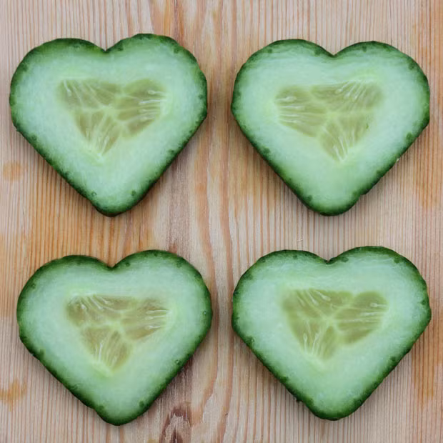 Slices of a heart-shaped cucumber are placed on a piece of wood at a nursery in Albertshofen, Germany. The garden shop offers cucumbers shaped like a heart for Valentine