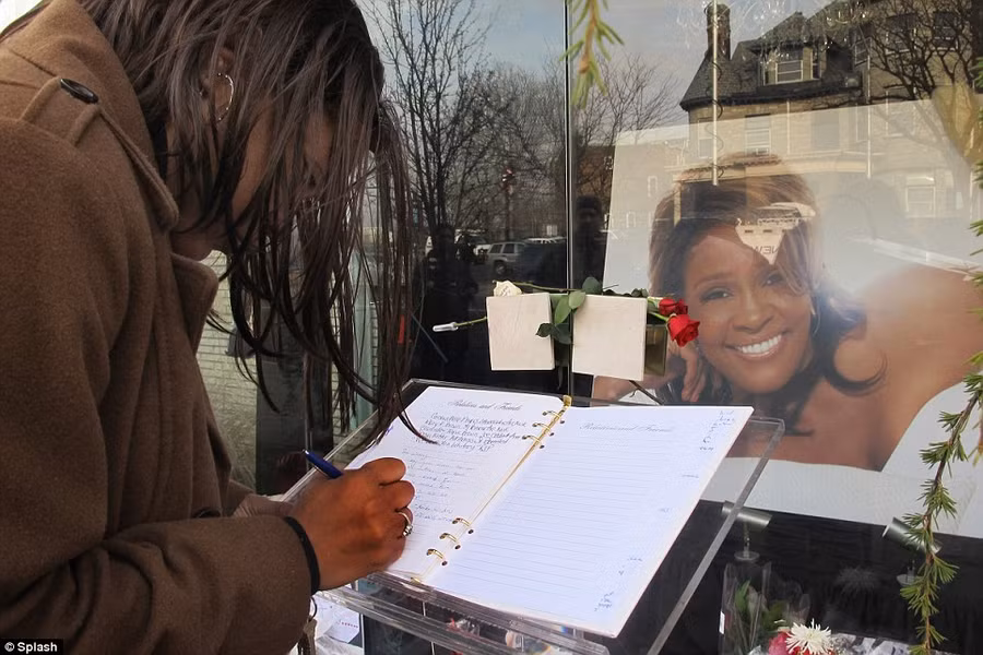 From the heart: A fan signs a memorial book as she pays her respects to the late singer, who died last Saturday Read more: http://www.dailymail.co.uk/news/article-2102985/Whitney-Houston-Funeral-A-galaxy-stars-gather-New-Jersey-say-goodbye-pop-legend.html#ixzz1mnFdRbT1
