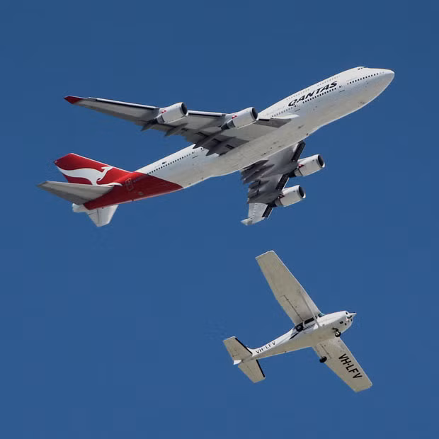 This Boeing 747 looks much too close for comfort to a tiny aeroplane. The passenger jet looms large over the Cessna 172N Skyhawk. Joel Thomas captured the scene over Archerfield Airport, located in the suburbs of Brisbane. He says the Cessna was performing a training flight, doing circuits at 1,000 feet, while the jet was approximately at 3,000ft. Trevor Potter, pilot of the Cessna, says: 