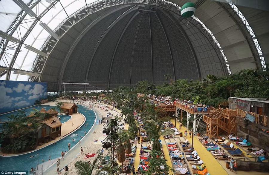 Holiday: The resort contains a beach, lagoon, water slide and adventure park. Guests can also enjoy numerous restaurants, evening shows and saunas Read more: http://www.dailymail.co.uk/news/article-2281349/Incredible-pictures-luxury-Tropical-Islands-resort-inside-enormous-German-hanger-surrounded-SNOW.html#ixzz2LQniKkPj Follow us: @MailOnline on Twitter | DailyMail on Facebook