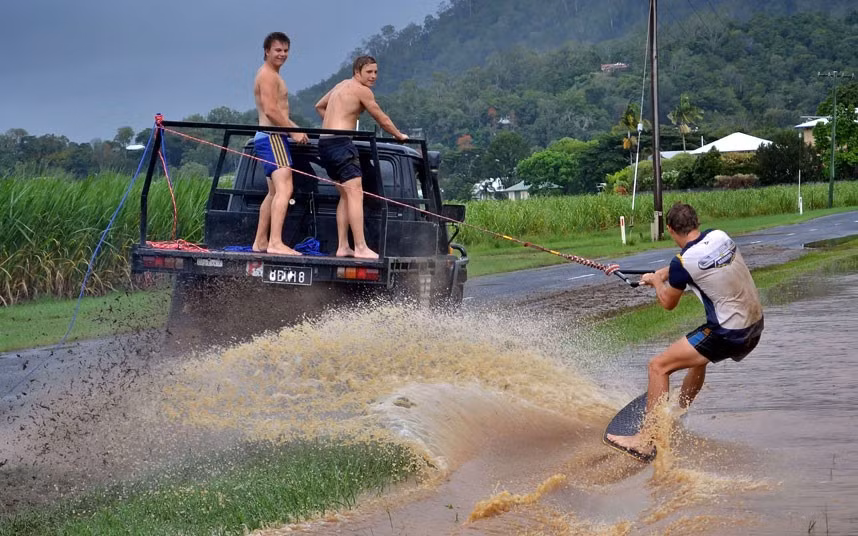 Wakeboarders make use of the floodwaters near Brimsmead just outside of Cairns, Northern Queensland
