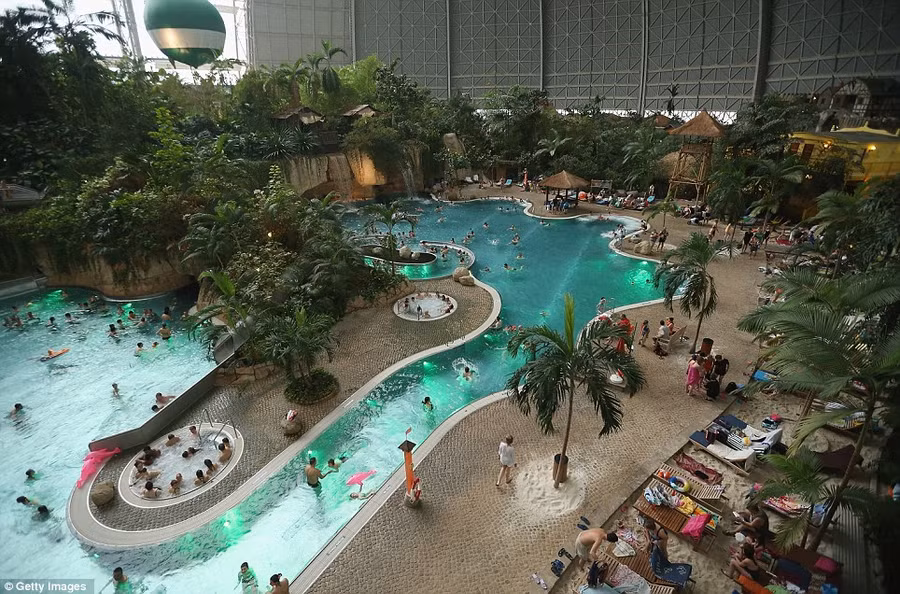 Relaxing: Tropical Islands is inside a hangar built originally to house airships designed to haul long-distance cargo. Visitors can be seen swimming in the lagoon at the resort Read more: http://www.dailymail.co.uk/news/article-2281349/Incredible-pictures-luxury-Tropical-Islands-resort-inside-enormous-German-hanger-surrounded-SNOW.html#ixzz2LQnWYvKl Follow us: @MailOnline on Twitter | DailyMail on Facebook