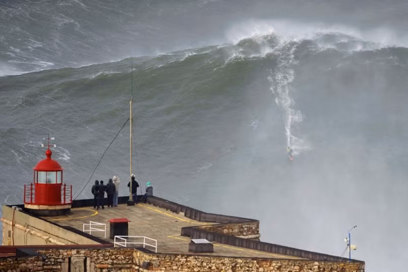 Big-wave surfer Garrett McNamara drops in on a large wave at Praia do Norte in Nazare. McNamara of Haleiwa, Hawaii, who won the Biggest Wave title at the 2012 Billabong XXL Big Wave Awards with his world record 78-foot (24-metre) wave ridden at Praia do Norte on November 1, 2011, has returned to Nazare because he wants to try to beat the record again, and the forecast for the next few days are for very big waves.