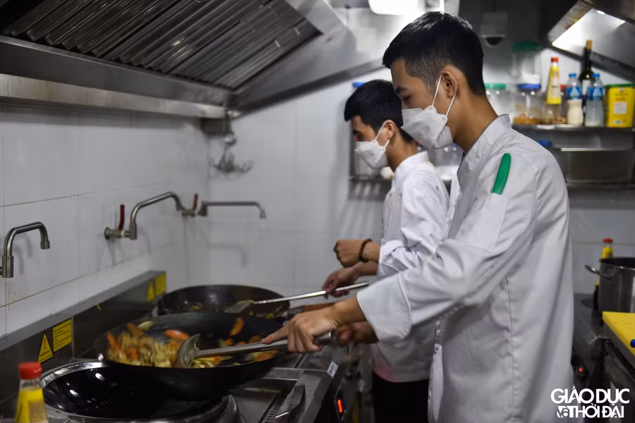 Đầu bếp liên tục làm hàng trăm suất cơm phía bên trong bếp.