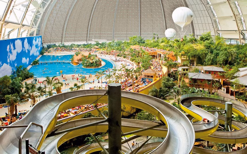 A tropical island paradise resort has been built inside an old airship hangar so big could easily fit eight football pitches in it. A sandy beach, spa, waterfall, whirlpools and water slides are just a few of the attractions . The indoor tropical island, located in Brandenburg, Germany, boasts an air temperature of 26 degrees, with water being 28C in the Tropical Sea and 32C in the Bali Lagoon. It is also host to the world’s biggest indoor rainforest, which features over 50,000 plants.
