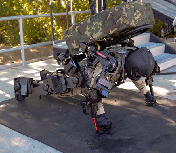 The week in pictures: 26 November 2010 XOS-2 test engineer Rex Jameson does push-ups during a demonstration at the Raytheon Sarcos research facility in Salt Lake City, Utah. The Raytheon second generation Exoskeleton (XOS 2) makes any wearer a real life ’Iron Man’. Developed by Salt Lake City based Raytheon Sarcos, the suit was designed to be used by the US military to allow one soldier to do the work of two or three, lifting heavy munitions, with an eye one day on bringing a field version for infantry into action. XOS-2 test engineer Rex Jameson does push-ups during a demonstration at the Raytheon Sarcos research facility in Salt Lake City, Utah. The Raytheon second generation Exoskeleton (XOS 2) makes any wearer a real life ’Iron Man’. Developed by Salt Lake City based Raytheon Sarcos, the suit was designed to be used by the US military to allow one soldier to do the work of two or three, lifting heavy munitions, with an eye one day on bringing a field version for infantry into action.