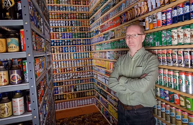 Nick West and part of his collection of 6,788 beer cans he has accumulated at his home over a period of 35 years