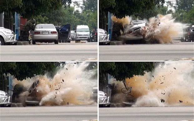 Những hình ảnh ấn tượng trong tuần ảnh 1 This combination photo shows a car bomb exploding as a member of a Thai bomb squad checks it in Narathiwat province, south of Bangkok. The bomb planted by suspected insurgents wounded the squad member, police said.