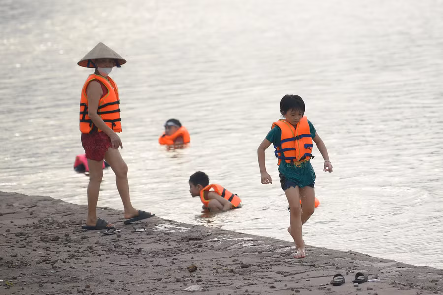 Các em nhỏ háo hức mặc áo phao và đeo kính bơi khi được người nhà cho đi tắm 'biển'. Các em nhỏ háo hức mặc áo phao và đeo kính bơi khi được người nhà cho đi tắm 'biển'.