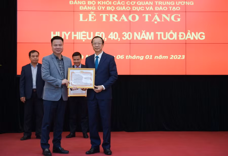 Thay mặt Đảng bộ Báo Giáo dục & Thời đại, đồng chí Triệu Ngọc Lâm – Bí thư Đảng uỷ Báo (bên trái) nhận Giấy khen của Đảng ủy Bộ GD&ĐT do Thứ trưởng Phạm Ngọc Thưởng - Bí thư Đảng ủy Bộ trao tặng.