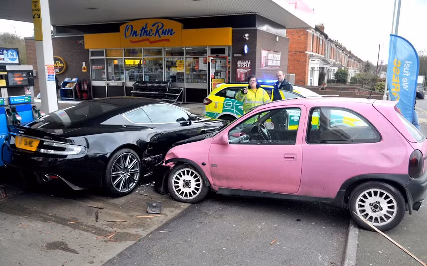 A shocked driver could only watch when his £100,000 Aston Martin DBS was written off while he filled up with petrol. The motorist had pulled up to a pump at the Esso garage in Kingshill, Wiltshire, when the driver of a pink Vauxhall Corsa lost control on the roundabout and she collided with his vehicle on the forecourt. Nobody was injured in the incident but the driver of the Aston Martin said his car was beyond repair. That will be a write-off. They won’t fix that, he said.