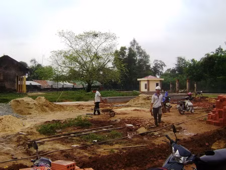Công nhân đang thi công cải tạo lại không gian của di tích tháp Chăm Khương Mỹ thay đổi cái “không gian của người Chăm xưa thành không gian người Chăm hiện đại” theo bê tông cốt thép và vườn hoa.
