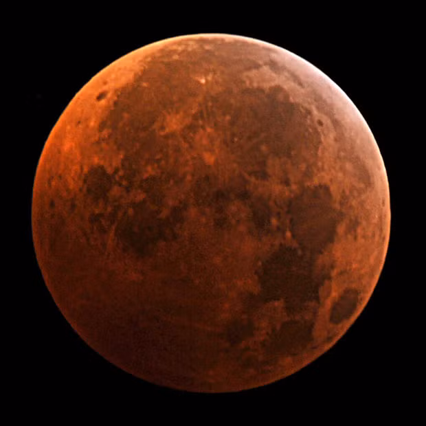 A picture taken in Manassas, Virginia, USA, shows the moon during the peak of the total eclipse 