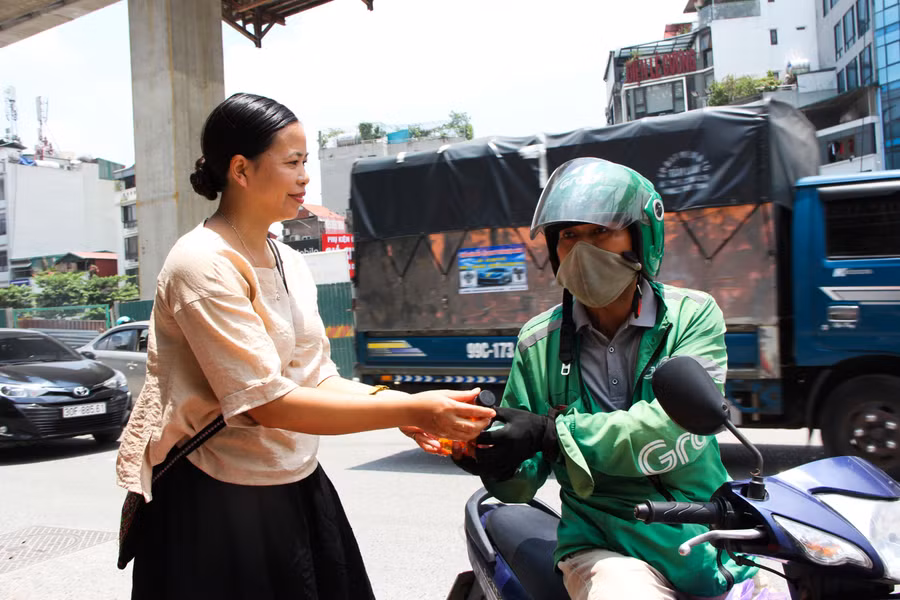 Người chạy xe ôm, shipper, thu mua phế liệu và bán hàng rong là những “khách hàng thân thiết” tại điểm phát nước miễn phí của vợ chồng ông Toàn. Anh Nguyễn Văn Tùng, một tài xế chạy xe ôm công nghệ cho biết: “Tôi chạy xe ôm công nghệ ở Hà Nội đã 3 năm nay rồi. Giữa thời tiết nắng nóng như thế này mà được tặng chai nước mát lạnh để uống thì cảm thấy sảng khoái, tỉnh táo và vơi bớt phần nào nóng nực giữa mùa hè”. Người chạy xe ôm, shipper, thu mua phế liệu và bán hàng rong là những “khách hàng thân thiết” tại điểm phát nước miễn phí của vợ chồng ông Toàn. Anh Nguyễn Văn Tùng, một tài xế chạy xe ôm công nghệ cho biết: “Tôi chạy xe ôm công nghệ ở Hà Nội đã 3 năm nay rồi. Giữa thời tiết nắng nóng như thế này mà được tặng chai nước mát lạnh để uống thì cảm thấy sảng khoái, tỉnh táo và vơi bớt phần nào nóng nực giữa mùa hè”.