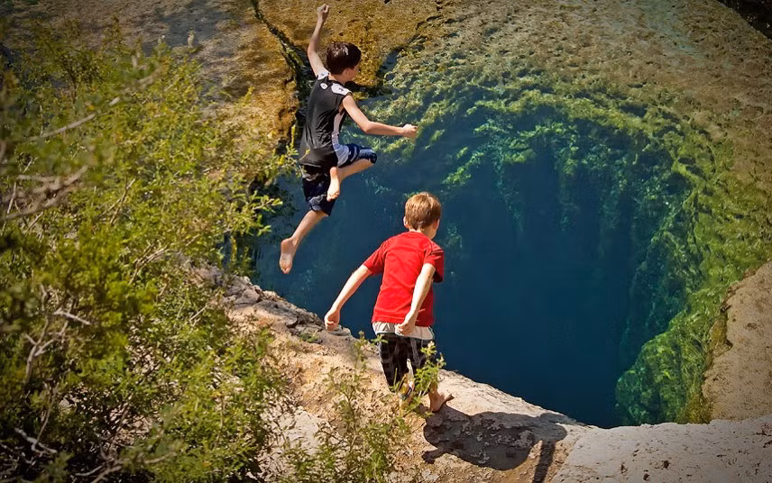 Jacob’s Well, an artesian spring that flows out of one of the deepest underwater caves in Texas, USA. The spot is very popular with people needing to cool off on hot summer days !