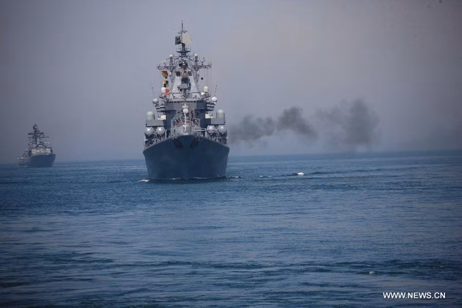 A Russian naval vessel fires a shell during the Russia-China joint naval exercise in the Yellow Sea of the Pacific Ocean, April 26, 2012. Chinese and Russian warships concluded a live ammunition exercise on Thursday, following a no-weapon joint war game earlier the same day