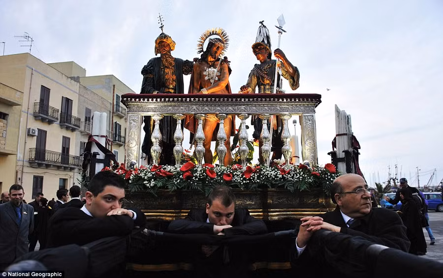 Andrea GuarnerI: During the Easter holy celebration called iMisterii in Trapani, the devotees carry the scenes of Christ’s passion on their shoulders all night long, only when the day comes do they take a break Read more: http://www.dailymail.co.uk/news/article-2189479/National-Geographic-reveal-winners-2012-Photo-Contest.html#ixzz23mBpSjth
