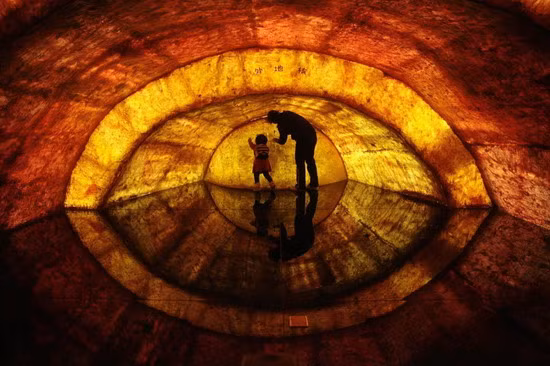 [CHINA] A woman and her daughter touch a structural model of the earth’s core at Nanjing Geological Museum in Nanjing, Jiangsu province April 22, 2011. Earth Day, which is celebrated on April 22 every year, marks an annual effort to raise public awareness about the environment and inspire actions to clean it up. The Chinese characters on the model read 