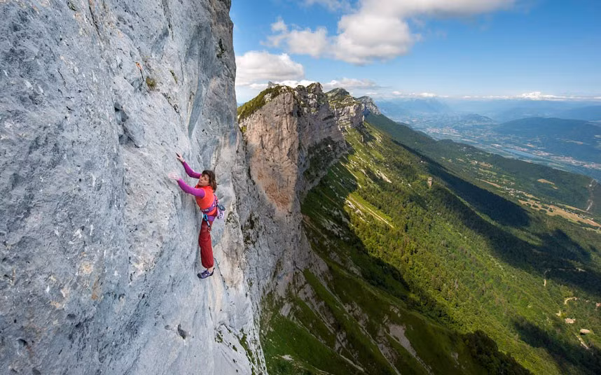 Nina Caprez scales the near vertical 820ft wall of La Dent de Crolles with just a thin rope keeping her from plunging to the ground. Nina Caprez spent seven hours scaling the tricky route up the huge slab of rock - dubbed Carnet d’Adresses - found in the Chartreuse Massif, near Grenoble, France. The climb is so steep it has been likened to climbing glass, with few holds for climbers to cling onto. It has meant that only four people - including Nina - have ever successfully free climbed the peak.