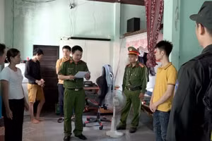 Lực lượng công an đọc lệnh giữ người trong trường hợp khẩn cấp đối với Võ Hữu Song (áo vàng thứ 2 từ phải sang)