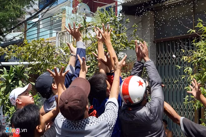 Họ chờ cho các gia đình cúng xong, tung tiền, đồ ăn để giành giật cho mình.