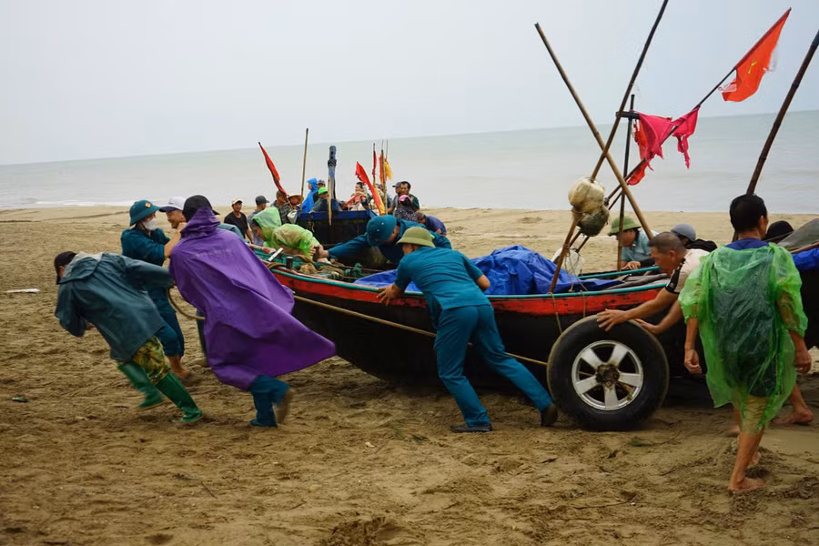 Ngư dân Thanh Hoá hối hả đưa thuyền lên bờ trước khi bão số 3 đổ bộ.