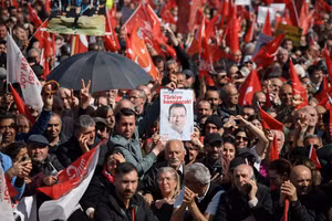 Người dân giơ cao tấm áp phích có dòng chữ "Thổ Nhĩ Kỳ sẽ chiến thắng" tại một cuộc biểu tình phản đối việc bắt giữ Thị trưởng Istanbul Ekrem Imamoglu trong khuôn khổ cuộc điều tra tham nhũng tại Istanbul, Thổ Nhĩ Kỳ, ngày 29/3. Ảnh: REUTERS.