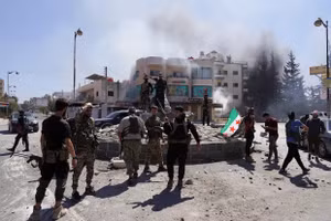 Các thành viên của lực lượng an ninh Syria đứng cùng nhau sau khi quân đội Syria tiến vào thành phố Suwayda, Syria, nơi có đông người Druze sinh sống. Ảnh: Reuters.