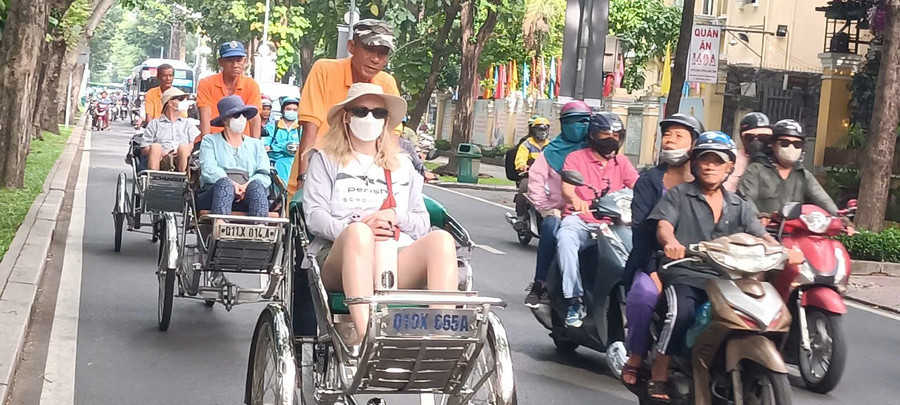 Khách quốc tế trải nghiệm dịch vụ xích lô tại TPHCM.