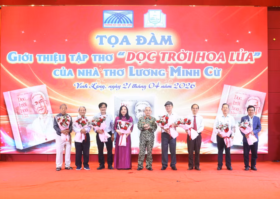 Nhà thơ Lương Minh Cừ tặng hoa cho các đại biểu trình bày tham luận.