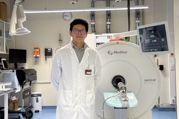 NCS Võ Hồng Phúc bên hệ thống PET/CT tiền lâm sàng dùng trong nghiên cứu tại Đức. Ảnh: NVCC.