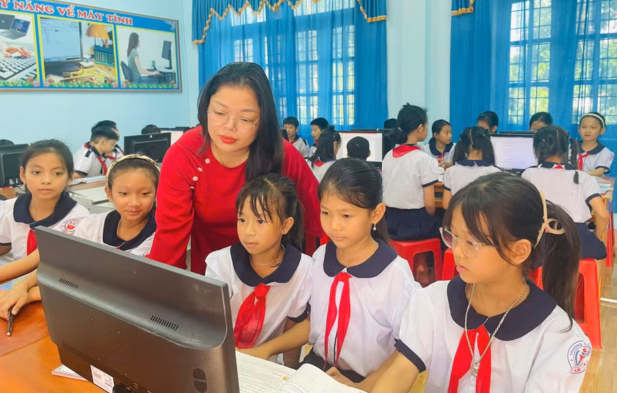 Cô giáo Trần Thị Huệ hướng dẫn học sinh thực hành môn Tin học. Ảnh: Đăng Đức