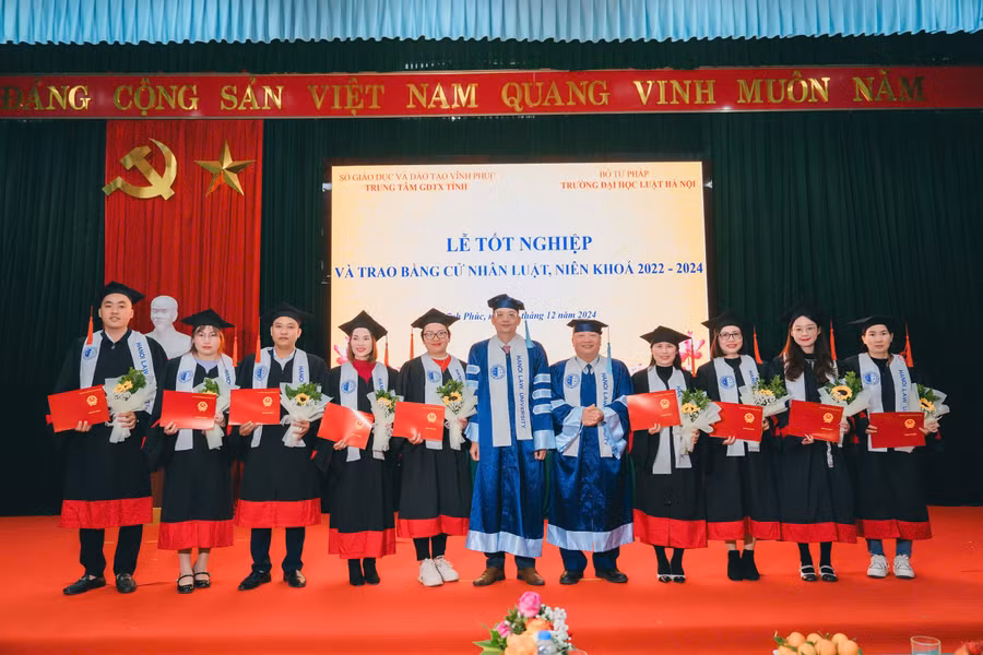 Lãnh đạo Trường ĐH Luật Hà Nội và lãnh đạo Trung tâm GDTX Vĩnh Phúc trao bằng cho tân cử nhân.