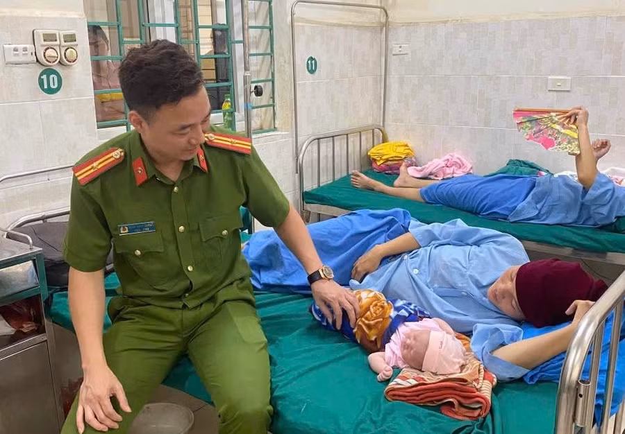Thiếu tá Cường đến bệnh viện thăm hỏi mẹ con chị Say. Ảnh: Công an tỉnh Hà Giang