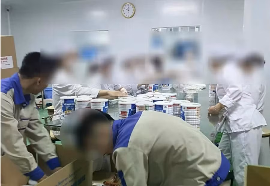 Công nhân đóng hộp thành phẩm sữa giả tại cơ sở sản xuất, chuẩn bị bán ra thị trường. Ảnh: CAND