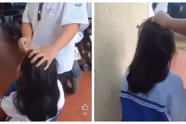 Nữ sinh bị túm tóc, bắt quỳ gối trước sự chứng kiến của nhiều học sinh khác. (Ảnh: Cắt từ clip)