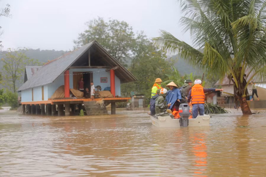 Lực lượng chức năng hỗ trợ người dân trong thời tiết mưa lớn, nước dâng cao.