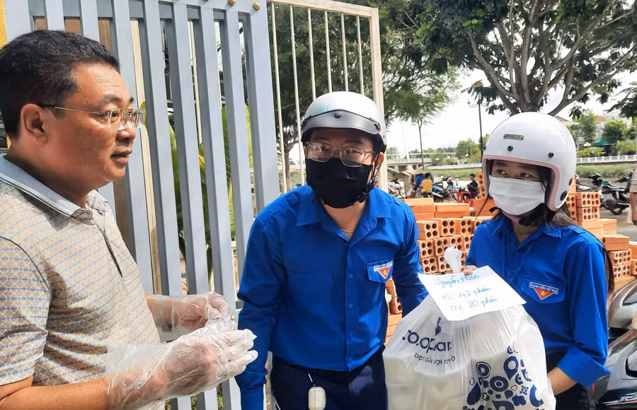 Tình nguyện viên nhận và vận chuyển các suất cơm đến các điểm thi