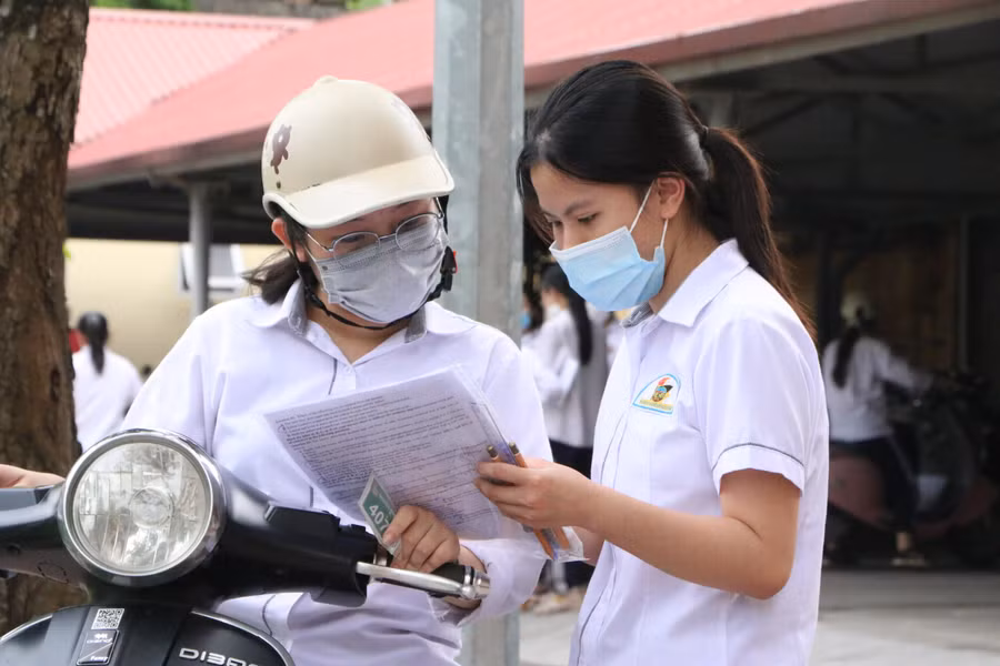 Các thí sinh tại Trường THPT Nguyễn Khuyến trao đổi bài sau khi kết thúc bài thi Tiếng Anh chiều 8/7.