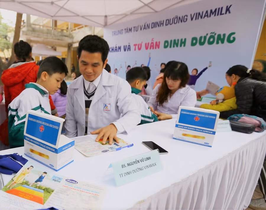 Bác sĩ dinh dưỡng của công ty Vinamilk khám sứ ckhỏe và tư vấn dinh dưỡng cho các em học sinh tại trường