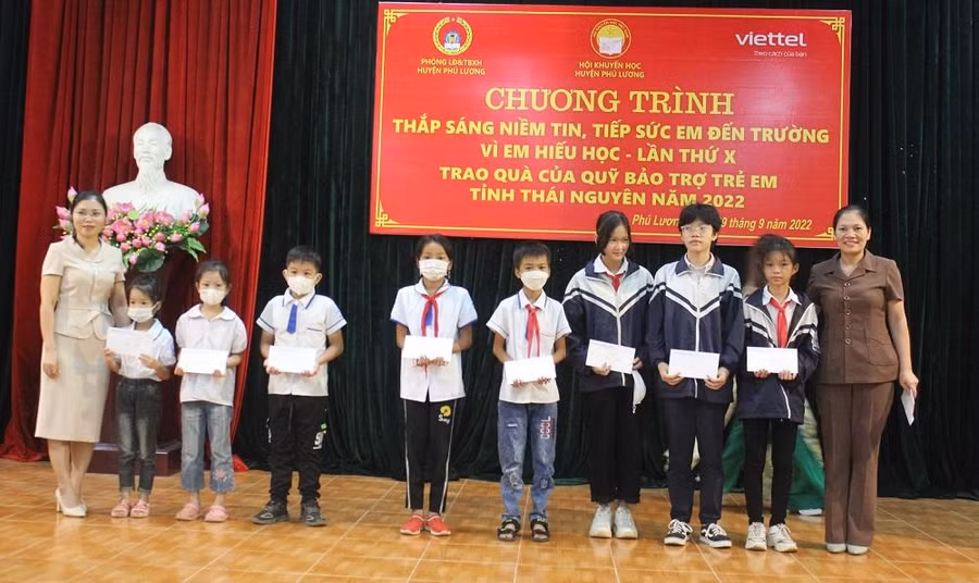 Đại diện lãnh đạo huyện Phú Lương trao học bổng cho các em học sinh