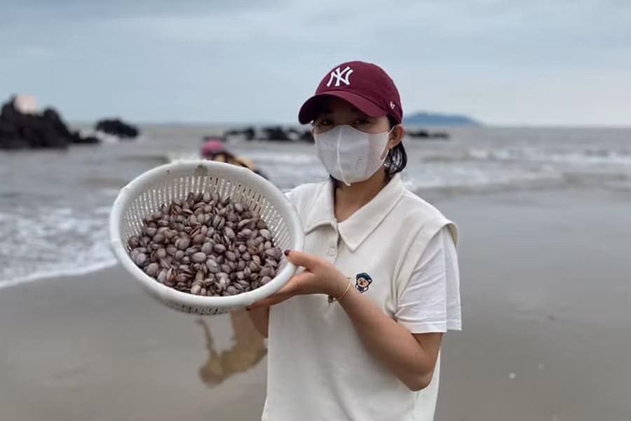 Cô gái phấn khởi khoe chiến lợi phẩm. Ảnh: NDCC