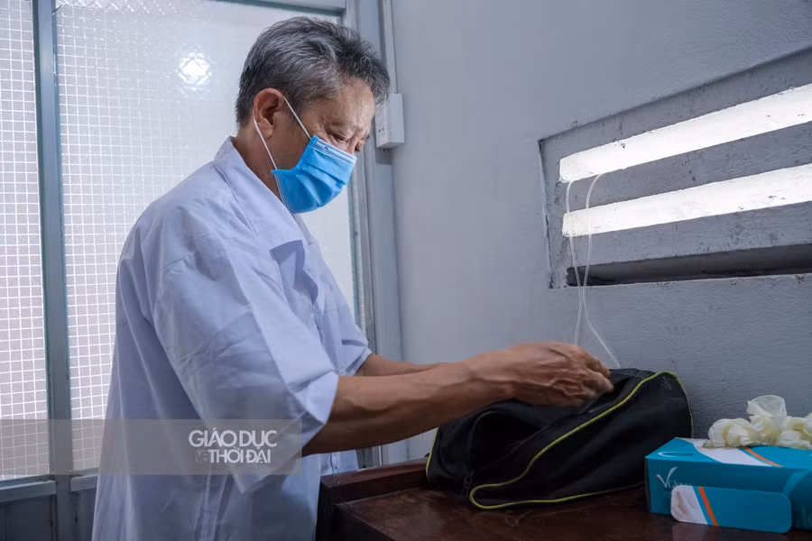 Ông Hoàng Khắc Hiến, một cán bộ y tế về hưu đang sắp dụng dụng cụ sẵn sàng hỗ trợ người dân khi cần.