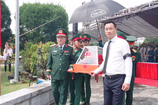 Ông Lê Ngọc Quang (áo trắng), Bí thư Thành ủy Đà Nẵng đưa các hài cốt liệt sĩ đi an táng. Ảnh: Quang Cường, Bộ CHQS Đà Nẵng