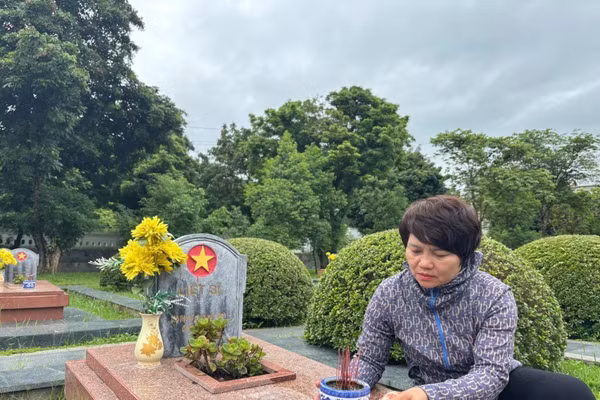 Bà Nguyễn Thị Miến đang tỉ mỉ lau phần mộ.