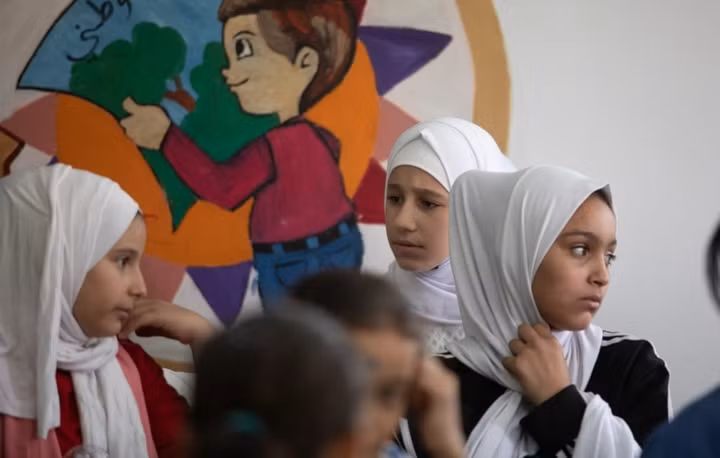 Các bé gái Syria tham gia lớp học tại trung tâm giáo dục cộng đồng Zarqa ở Jordan. Trẻ tị nạn đối mặt với vô số rào cản khi tiếp cận với hệ thống giáo dục tại quốc gia sở tại. Đôi khi các em không thể tới trường do vấn đề giao thông hoặc do không có sách vở.