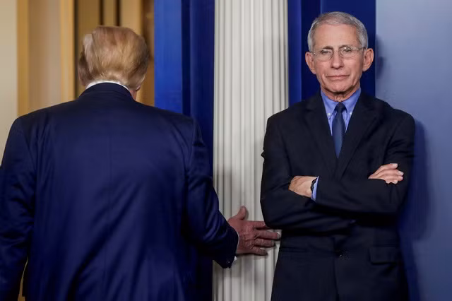 Ông Trump rời đi sau khi dự họp báo với Tiến sĩ Anthony Fauci, một nhà nghiên cứu bệnh học người Mỹ, tại Nhà Trắng ngày 26/3/2020 - Ảnh: REUTERS