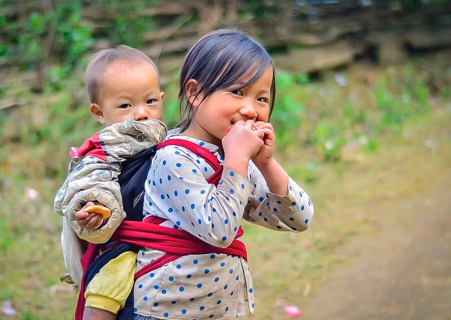 Trẻ lớn hơn thường được giao nhiệm vụ trông em để bố mẹ đi làm.