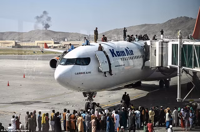 Tại sân bay Kabul, người tị nạn trèo lên nóc máy bay.